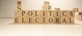 Electoral politics Word from wooden cubes. Economy state government terms Royalty Free Stock Photo