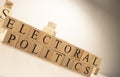 Electoral politics Word from wooden cubes. Economy state government terms Royalty Free Stock Photo