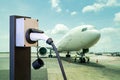 Electric aircraft charger station with plug and power cable supply on cargo or airplane parking with blue sky background