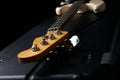 Electric Bass guitar headstock on black leather hard case Royalty Free Stock Photo