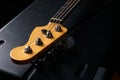 Electric Bass guitar headstock on black leather hard case Royalty Free Stock Photo