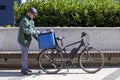 electric bicycle delivery person preparing order for delivery