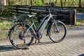 Electric bicycle of the German brand NCM on the pavement in front of the courtyard entrance ready for the start of the bicycle