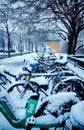 electric bikes parked at subway stop under snowfall