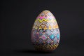 An electric blue Easter egg with a pattern on black background Royalty Free Stock Photo