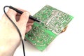 Electric Board in hand black probe, I conduct measurements for repair on a white background