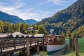 An electric boat on the Konigsee in Germany stands on a dock, a tourist spot, a vacation spot and beautiful alpine scenery
