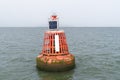 Electric bollard light or buoy on the open sea in the esuary of the Thames, England, UK