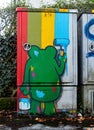 Electric box covered in colourful grafitti.