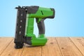 Electric Brad Nailer on the wooden planks, 3D rendering