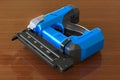 Electric Brad Nailer on the wooden table, 3D rendering