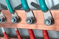 Cables or wires are connected to the electrical busbar by means of cable lugs.