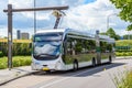Electric bus being recharged while stationary at a bus stop Royalty Free Stock Photo