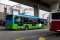 Electric bus at a stop is charged by pantograph. Clean mobility