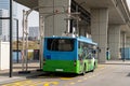 Electric bus at a stop is charged by pantograph. Clean mobility