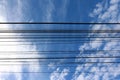 Electric cable with blue sky white clouds Royalty Free Stock Photo