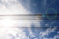 Electric cable with blue sky white clouds Royalty Free Stock Photo