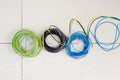 Electric cable coil in three colors black blue and earth