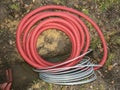 Electric cable in the flexible safety pipe in pit Royalty Free Stock Photo
