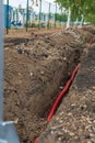 Electric cable laying in underground trench. fiber optic cable for fast internet Royalty Free Stock Photo