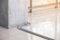 Electric cable pipe or conduit fixing on the concrete floor Construction work. Wiring system installation inside the building Royalty Free Stock Photo