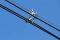 Electric cable wires with spacer damper on blue sky background