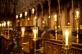 Electric candles in choir stalls, Ripon cathedral. Bokeh background. Royalty Free Stock Photo