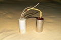 Electric capacitor device used to store an electric charge with wire for ceiling fan Royalty Free Stock Photo