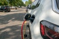 Electric car: being recharged, connected with the red cable to the electrical control unit Royalty Free Stock Photo