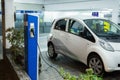 Electric car charged on a charging station in a indoor parking Royalty Free Stock Photo