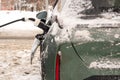 An electric car is charged from a charging station in winter. Eco transport. Energy Royalty Free Stock Photo