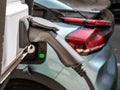 electric car charging. charging cable handle on the background of the car in defocus
