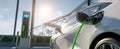 The electric car charging at a modern station under a bright sky..AI generated image Royalty Free Stock Photo