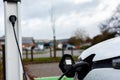 Electric car charging at plug in charge station in a public car park in Suffolk, UK