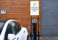 Electric car charging at public recharging point in UK