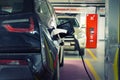 Electric car at charging station indoor underground parking in basement floor office, mall or residential building. Power supply Royalty Free Stock Photo