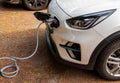 Electric car with charging station in the process of charging Royalty Free Stock Photo