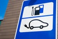 Electric car charging station sign in front of public parking lot Royalty Free Stock Photo