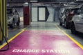 Electric car charging station in underground indoor parking of mall or office building. Reserved parking lot for environment Royalty Free Stock Photo