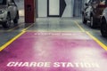 Electric car charging station in underground indoor parking of mall or office building. Reserved parking lot for environment Royalty Free Stock Photo