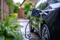 An electric car connected to a charger at a charging station, ready to recharge its batteries, A hybrid electric vehicle charging