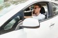 Electric car driver - green energy biofuel concept. Male behind wheel. Man driving new ecofriendly vehicle Young male owner proud Royalty Free Stock Photo