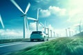 Electric Car Driving Past Windmills on a Road