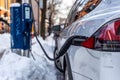 Electric car getting charged in Montreal after snowstorm Royalty Free Stock Photo