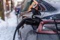 Electric car getting charged in Montreal after snowstorm Royalty Free Stock Photo