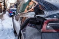 Electric car getting charged in Montreal after snowstorm Royalty Free Stock Photo