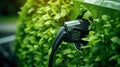 Electric Car Made from Plants Charging At Station. Close-Up View Of Electric Car Charger. Eco Drive. Generative AI Royalty Free Stock Photo