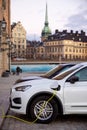 Electric car at the charging point. Sustainability and future of the nature and clean world.