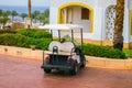 The electric car is in the Parking lot of the resort city. A car standing alone, rear view. A white Golf cart is parked near the Royalty Free Stock Photo
