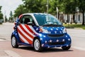 Electric car on the street of a city, painted in the colors of the American flag Royalty Free Stock Photo